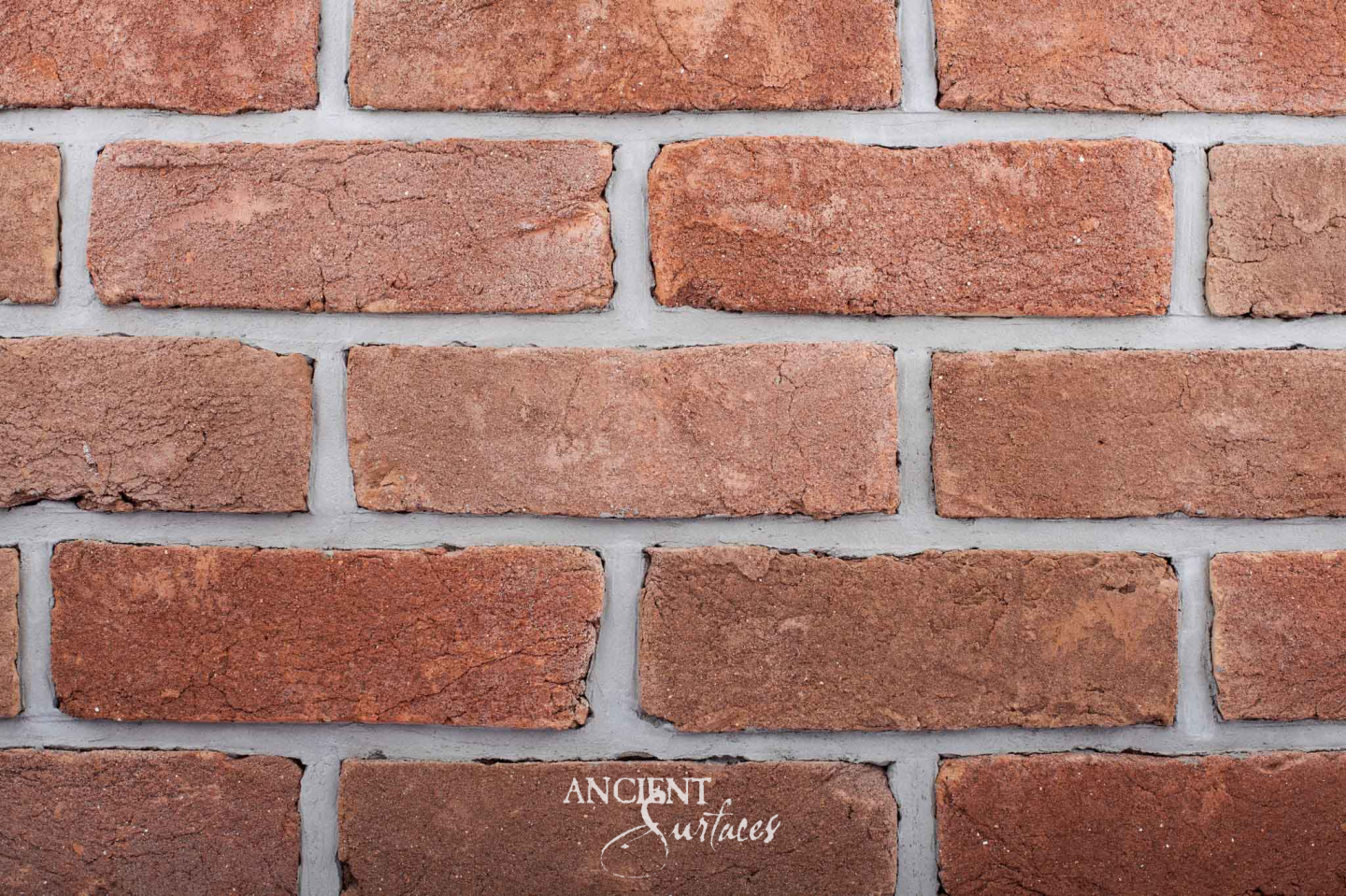 Ancient Surfaces reclaimed antique brick in warm terracotta and red with pale lime mortar joints
